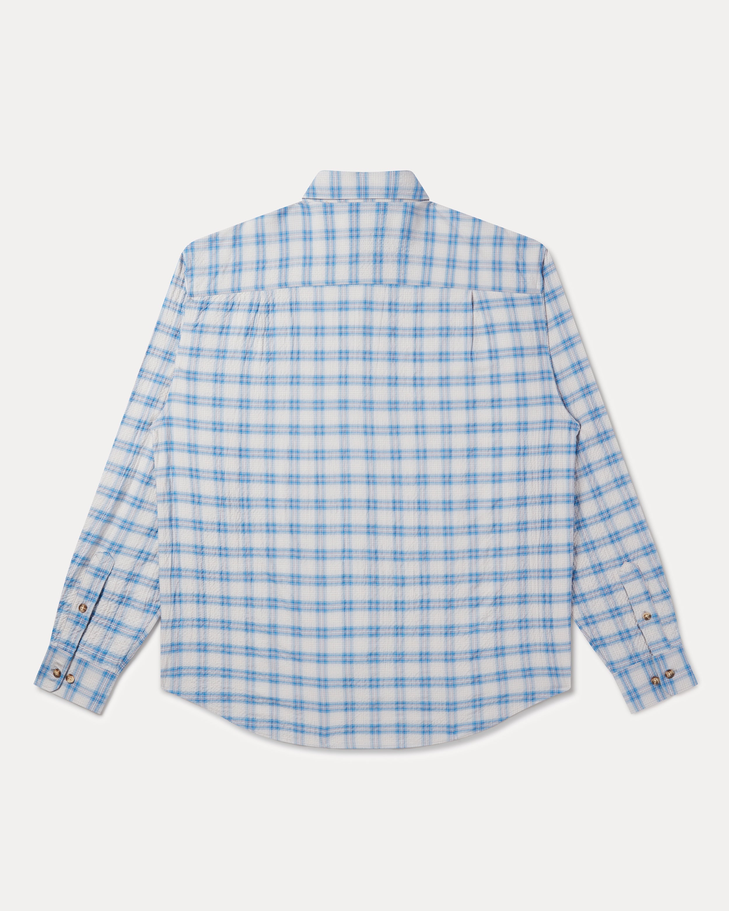 A long-sleeve button-up shirt with a light blue and white checkered pattern: Fera's Avon Shirt in blue and grey seersucker.