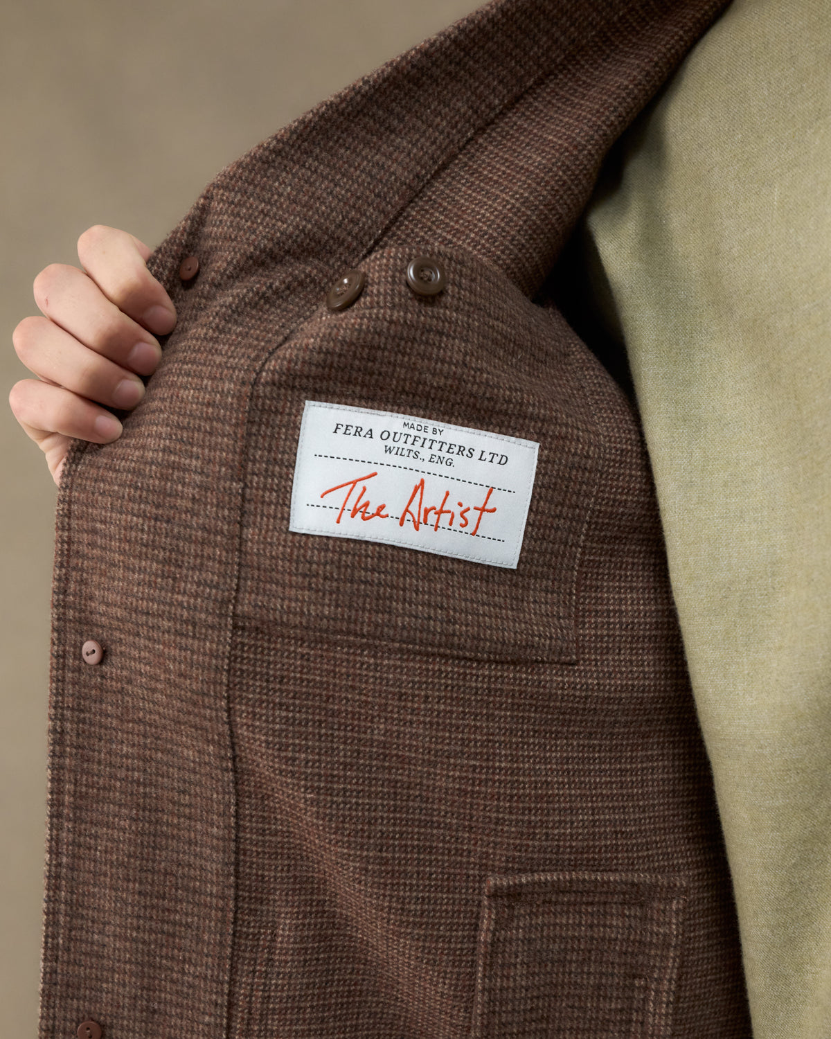 Close-up of the Fera Studio Jacket in Tweed showing the interior Fera Outfitters "The Artist" label