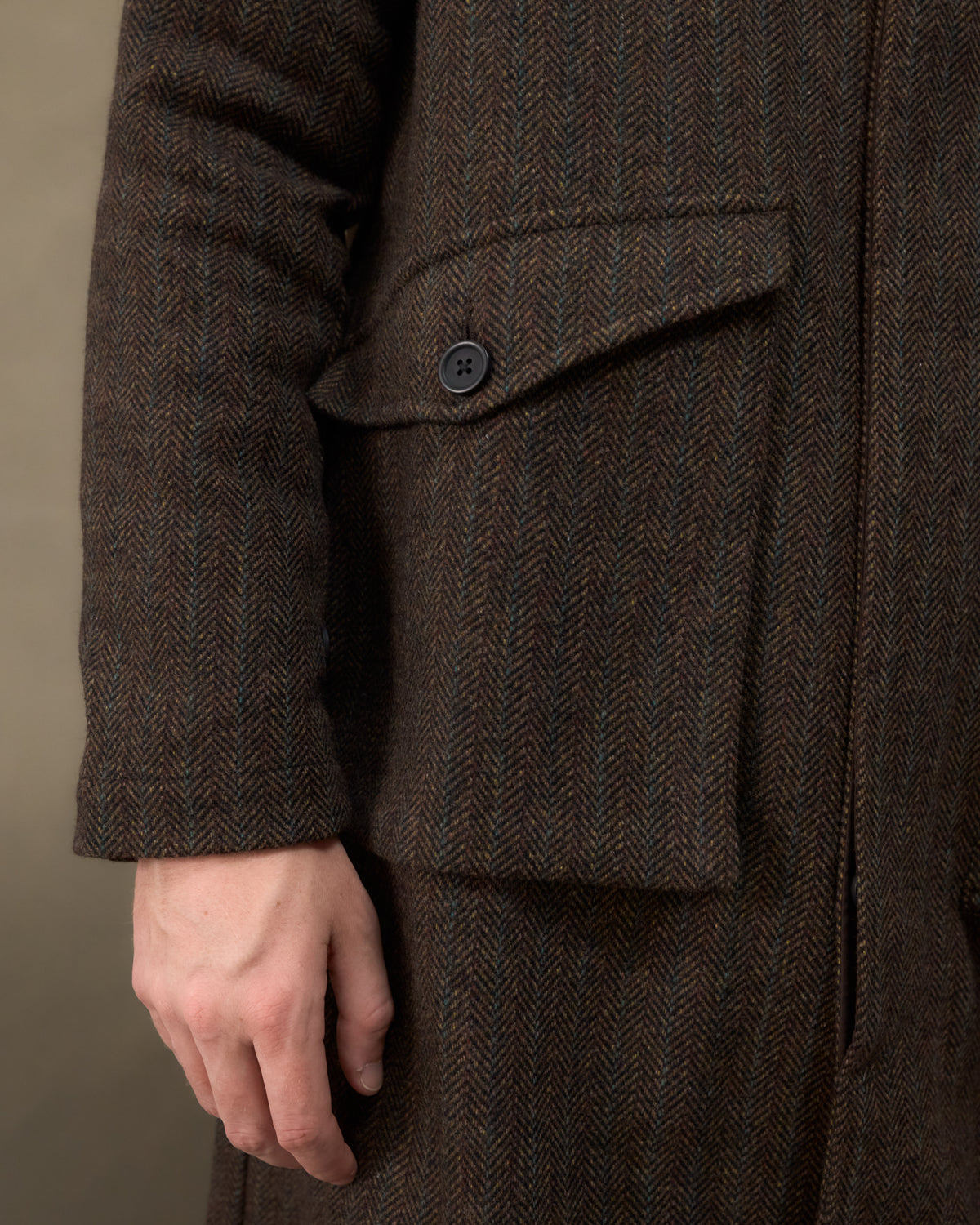Close-up of the Fera Marwood Coat in Tweed Herringbone showing the gusset flap hip pocket