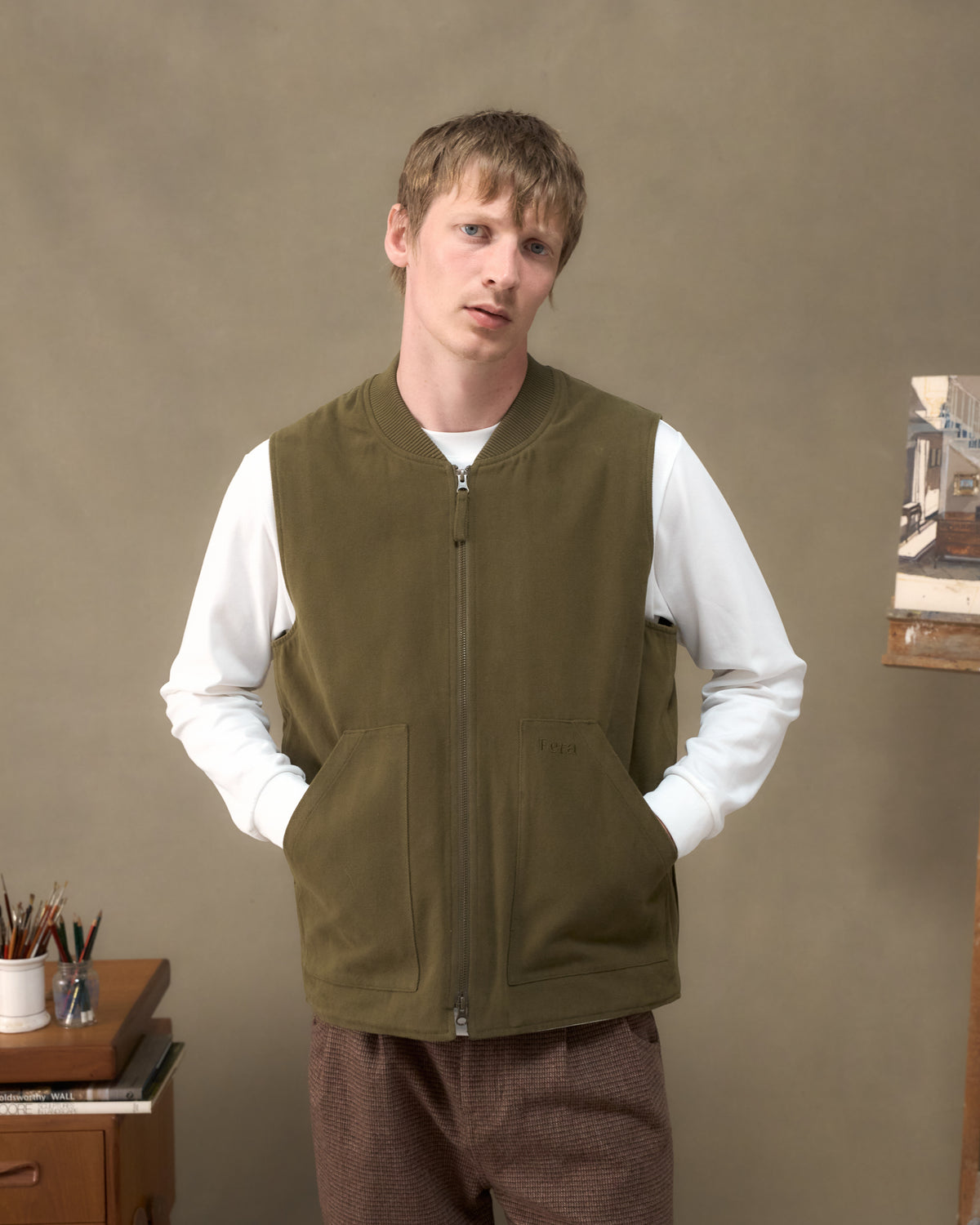 Model wearing the Fera Poacher Gilet in Marsh Green with hands in the kangaroo pockets