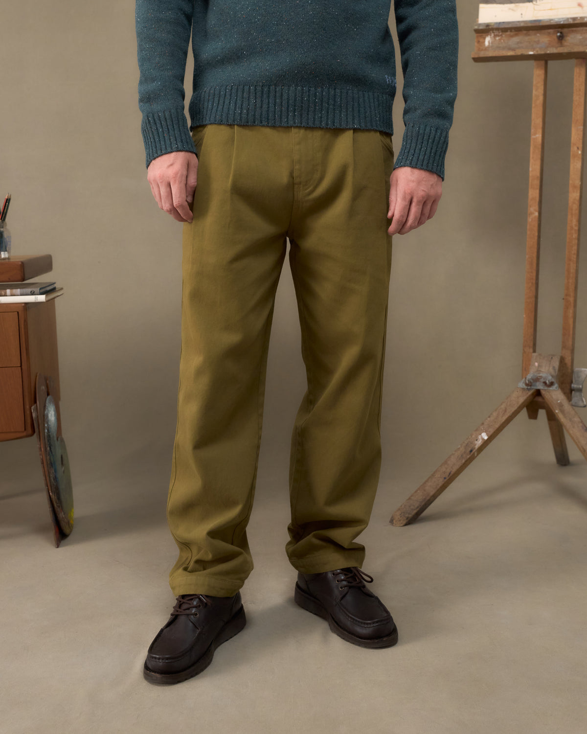 Fera Uniform Trousers in Moss worn with a teal Peewit Knit, cropped view of the relaxed straight leg