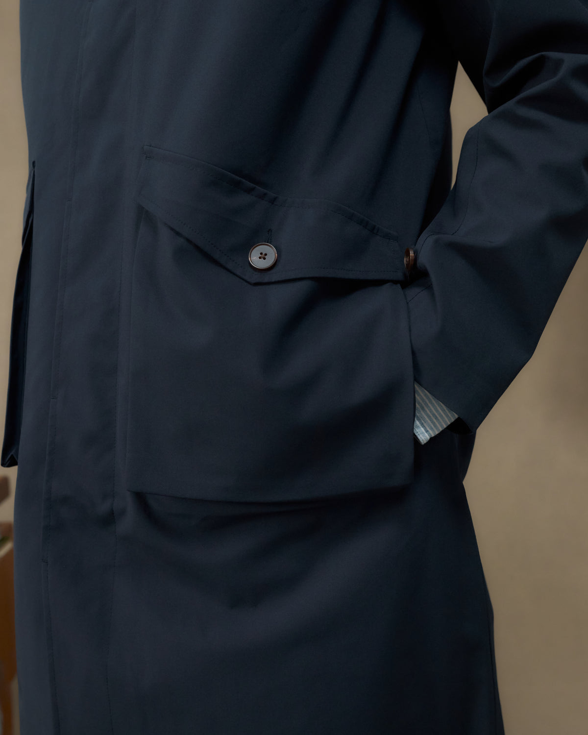 Close-up of the Fera Marwood Coat in Navy showing the gusset flap hip pocket and handwarmer entry